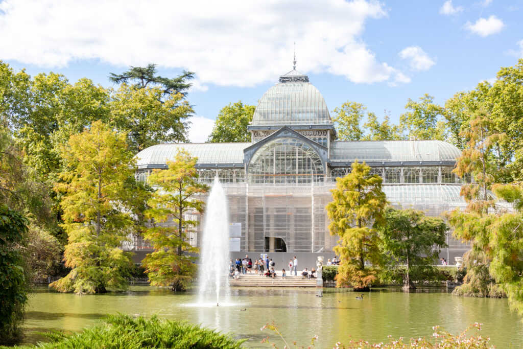 pond fountain shoots up water in front of the crystal palace Retiro park madrid 