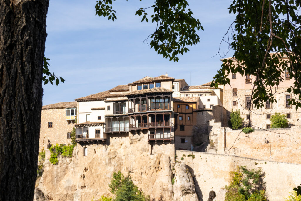 view of hanging houses in Cuenca, spain from across the river