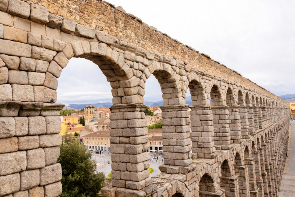 view through the arches of the roman aqueduct in Segovia, spain