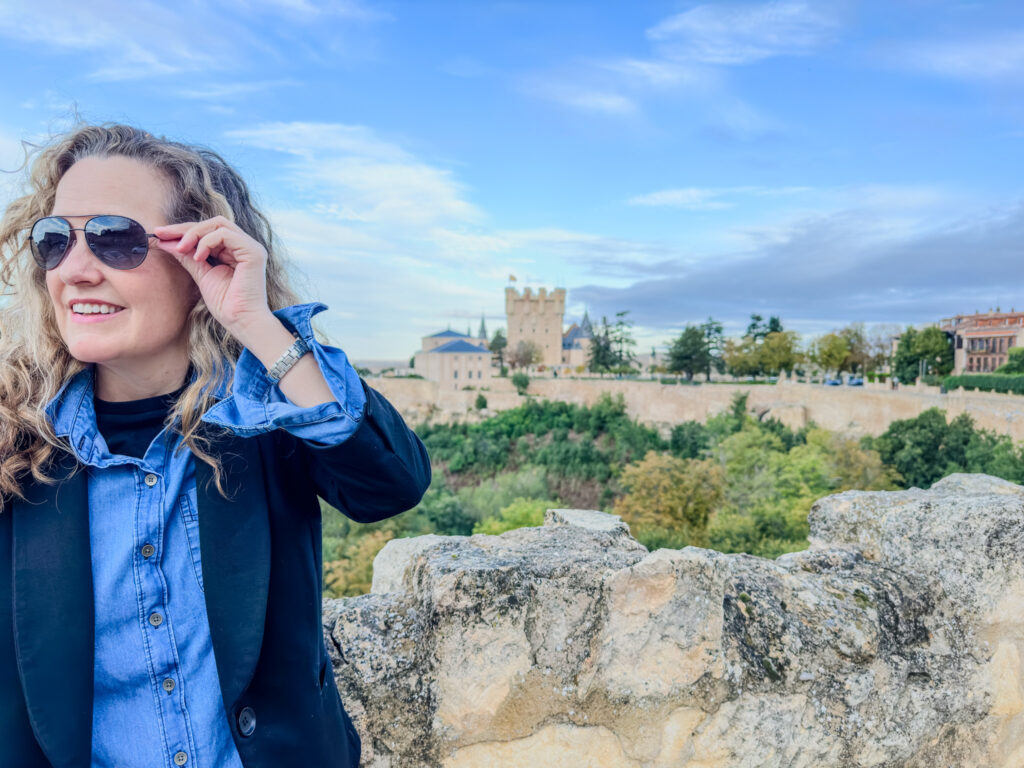 author with castle in background at city wall in Segovia