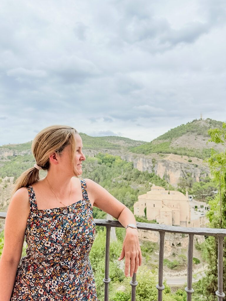 the author on a balcony with the Cuenca, spain parador in the background