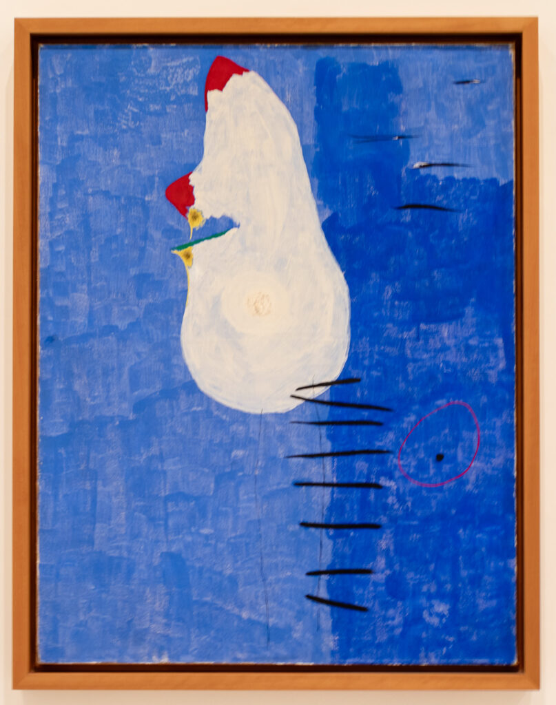 painting of abstract white blob against cobalt blue background in Reina Sofia museum madrid