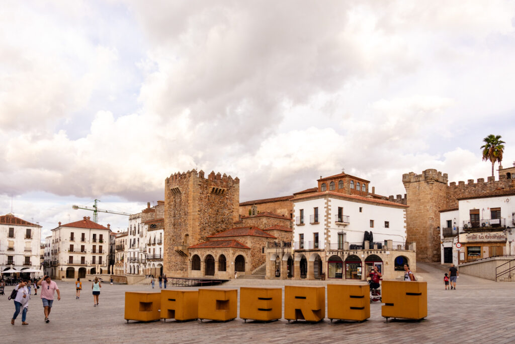 caceres sign and Bujaco tower from plaza mayor in spain