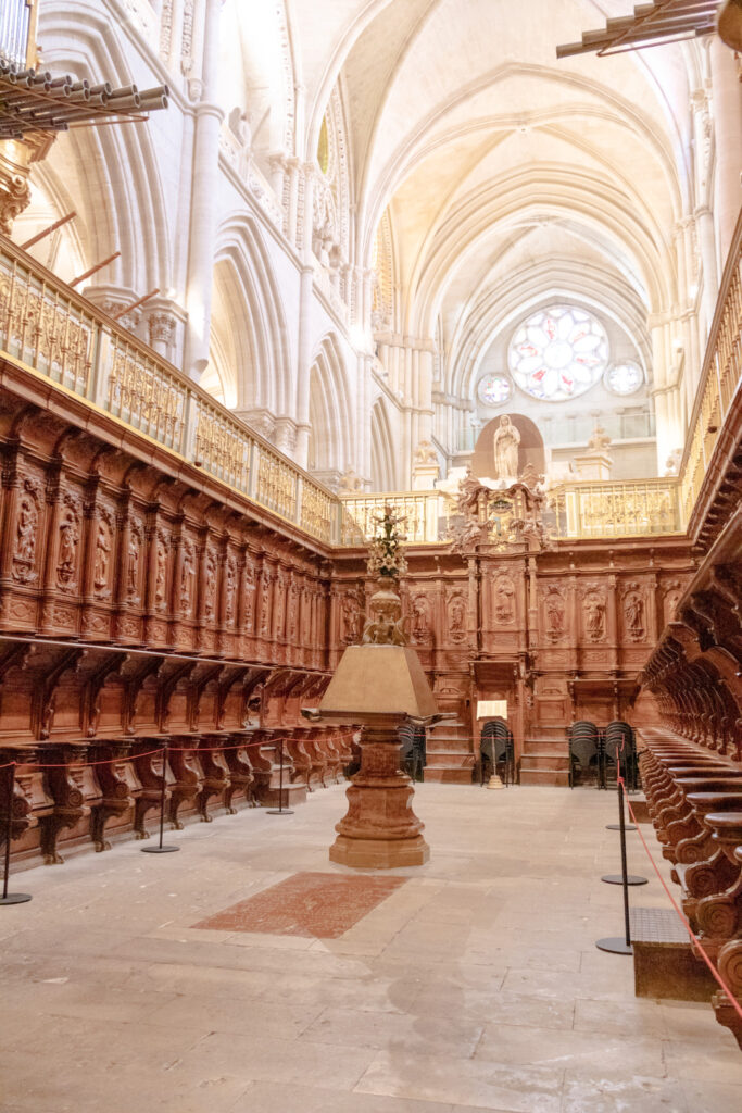 view of chapel with fold-down wooden seats in cathedral in Cuenca spain