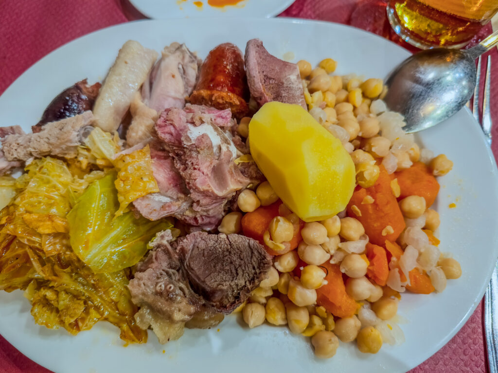 Cocida stew of chickpeas, carrots, potato, cabbage, and a variety of meats and sausages at fatigues del querer restaurant in madrid