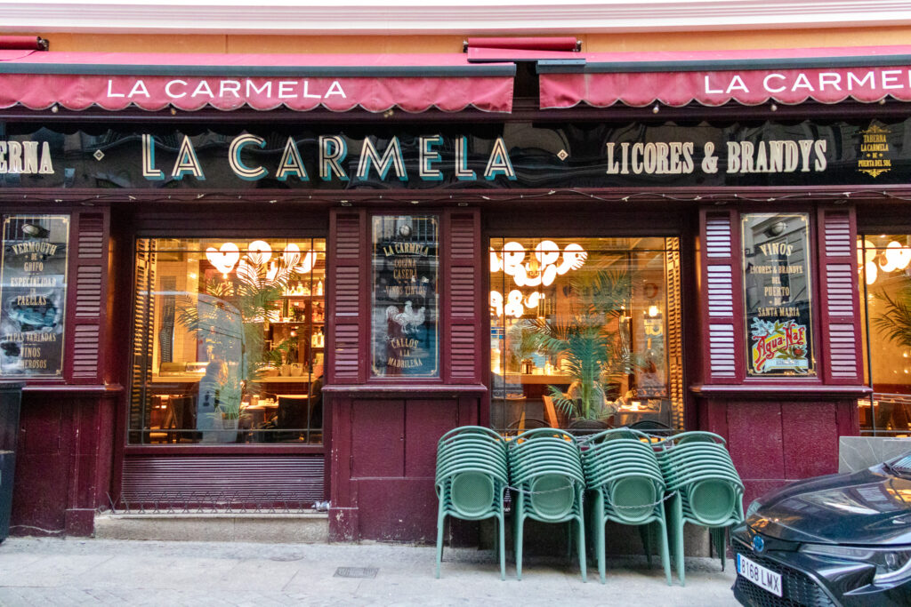 exterior of la Carmela restaurant with chairs stacked in front madrid