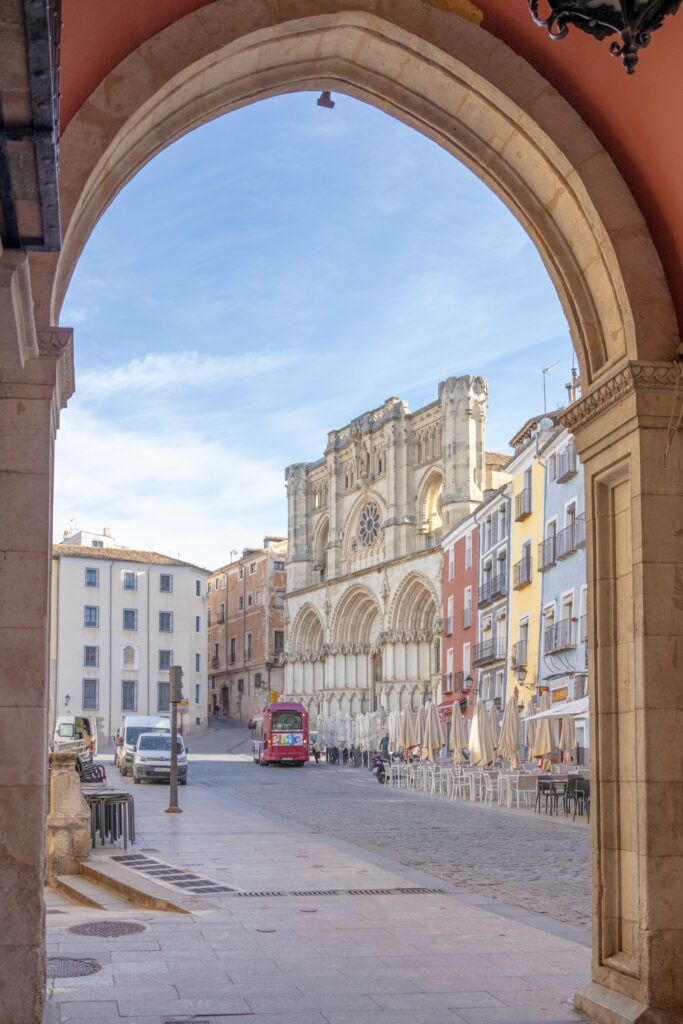 view through arch of Cuenca cathedral and plaza mayor in Cuenca spain