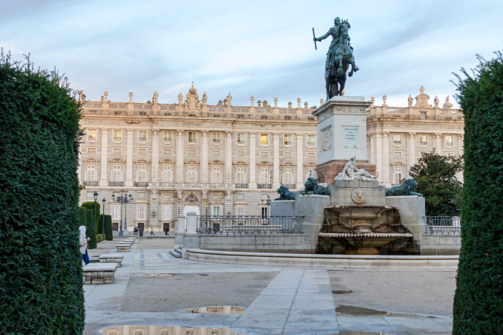 statue in from of the royal palace madrid from oriental garden