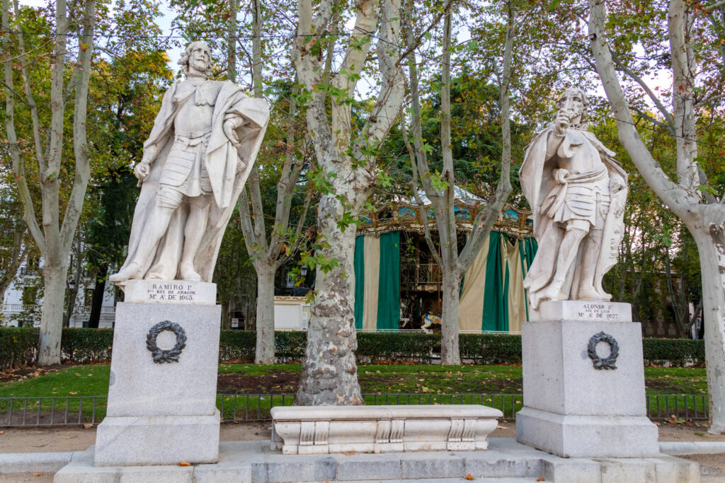 statues and carousel in oriental garden madrid, spain