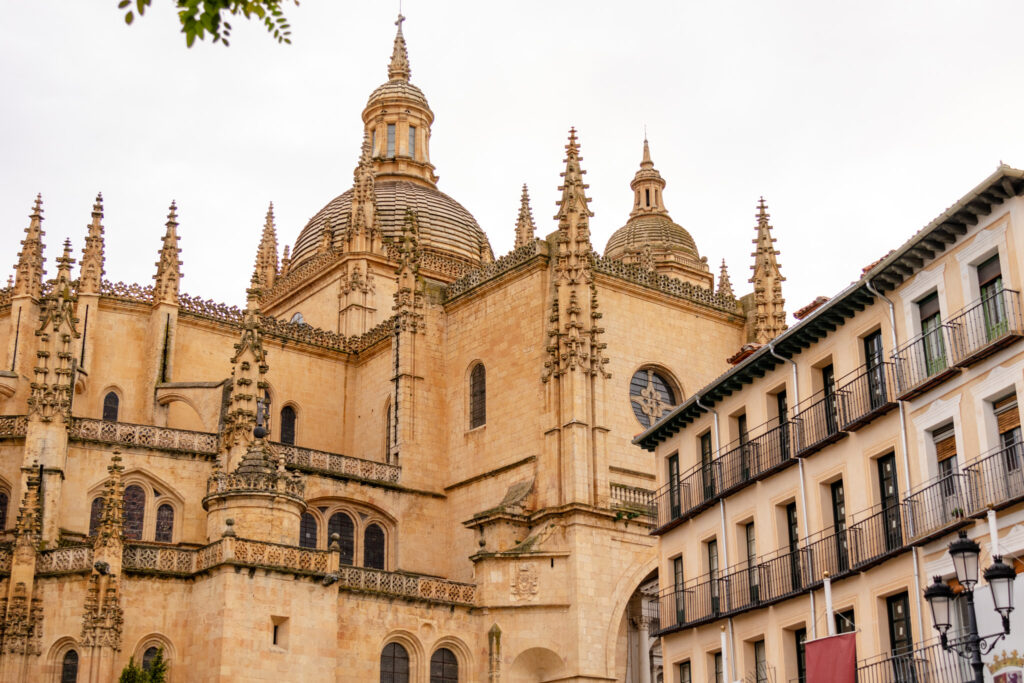 ornate spires of the segovia cathedral and one of the buildings of plaza mayor