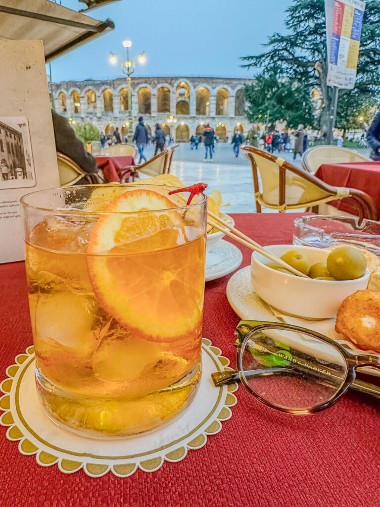 aperitivo in Verona italy with the arena in the background