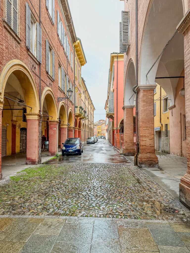 cobblestone and colonnaded street modena italy