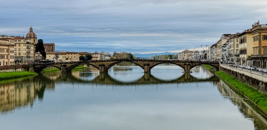 bridge reflected in the Arno river Florence, italy