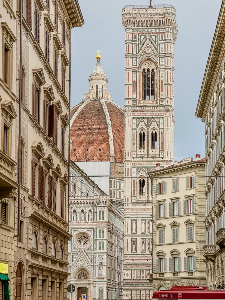 view of the Duomo between buildings in florence italy