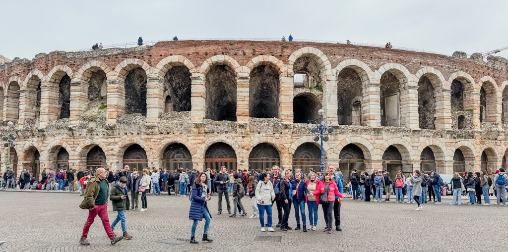 people taking photos in front of the ancient verona arena italy