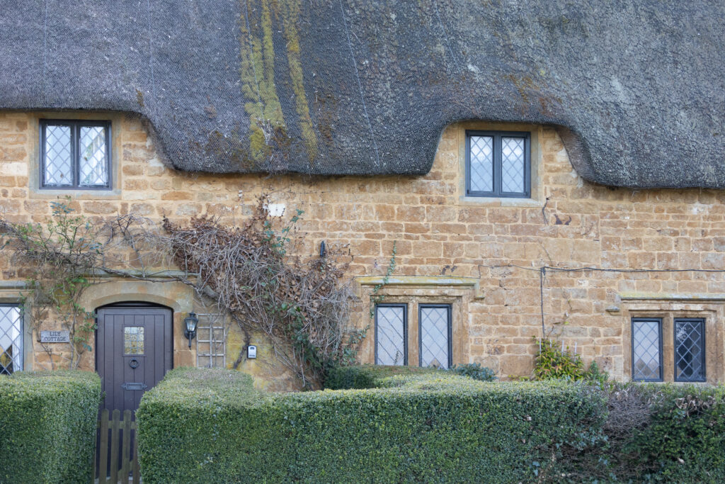 great-tew-cotswolds-close ✈️ Hey There Travel thatched roof cottage in Cotswolds