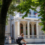 what to do in Shkodër a man rides a bike in front of Shkoder city hall